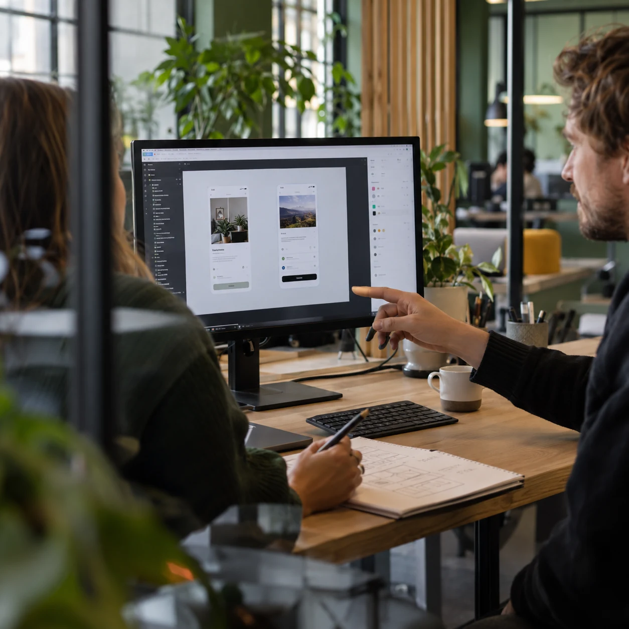 AI-generated scene of two designers discussing screen designs and paper sketches, accompanying the Figma story.